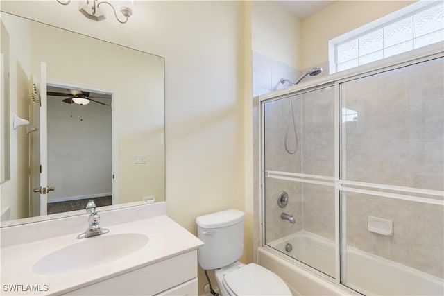 full bathroom featuring bath / shower combo with glass door, ceiling fan, vanity, and toilet