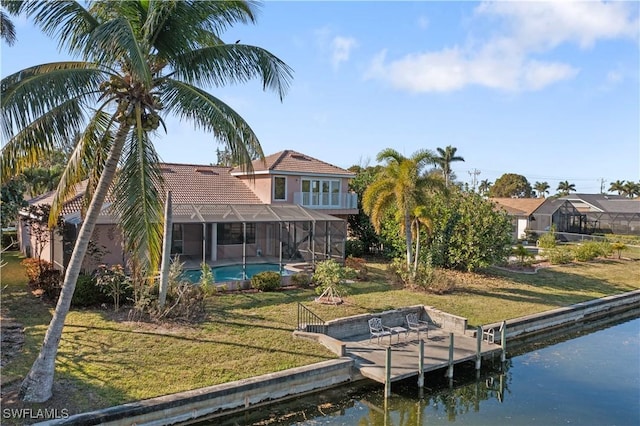 view of dock featuring a lanai, a lawn, and a water view