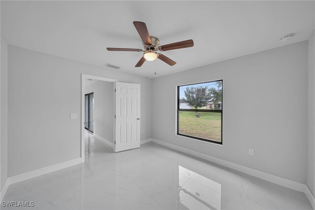 unfurnished room with ceiling fan