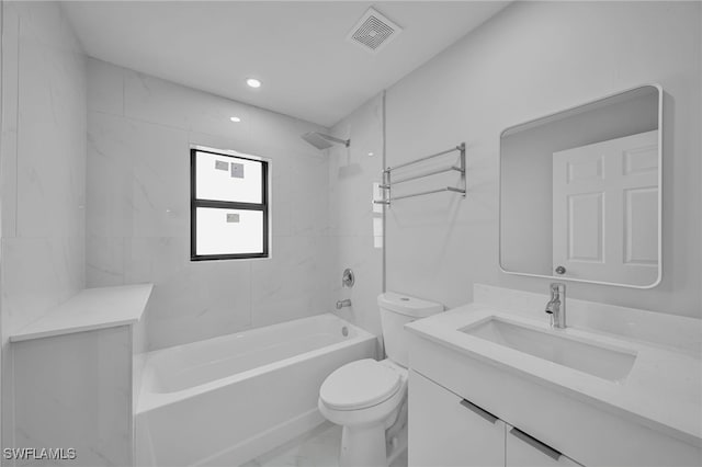 full bathroom featuring vanity, tiled shower / bath combo, and toilet