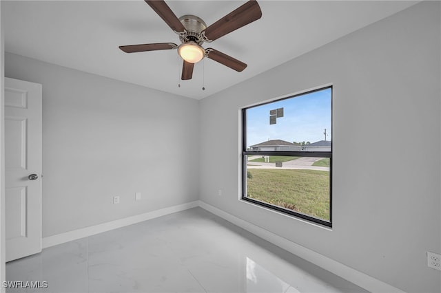 empty room with a wealth of natural light and ceiling fan