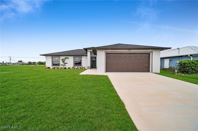 view of front of home featuring a garage and a front yard