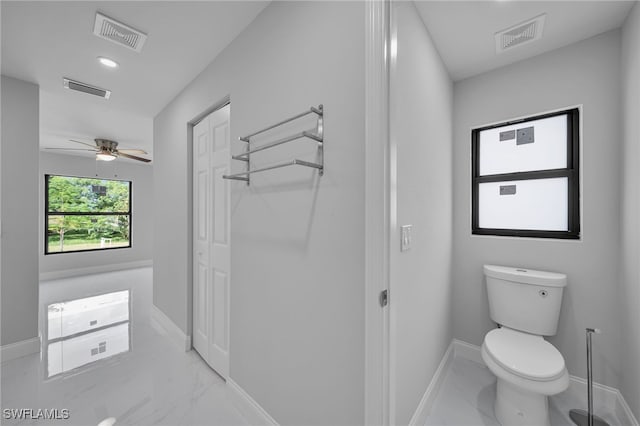 bathroom featuring ceiling fan and toilet