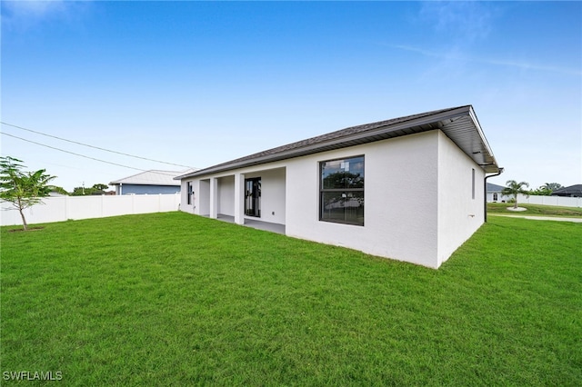 back of house featuring a yard