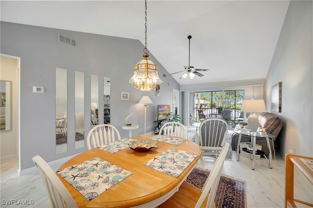 dining room featuring high vaulted ceiling and ceiling fan with notable chandelier