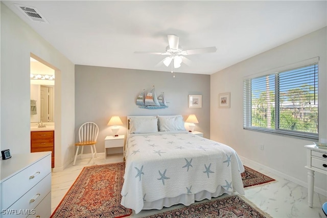3032 Sandpiper Bay Cir Unit G305, Naples, FL 34112 - bedroom featuring light marble finish flooring, a sink, baseboards, ceiling fan, and ensuite bathroom