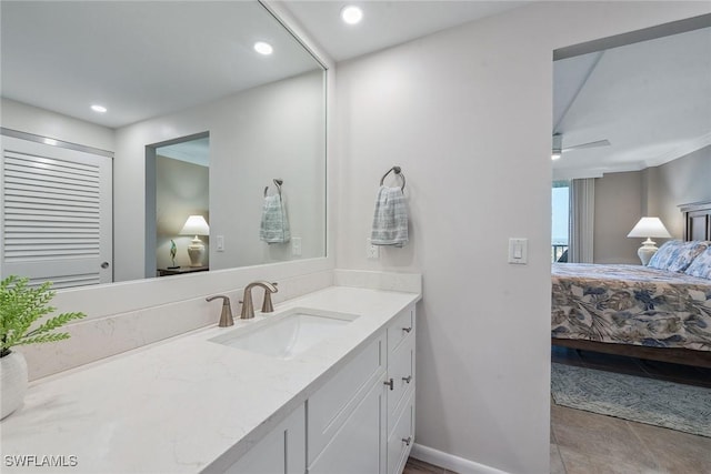 bathroom with tile patterned floors, ceiling fan, and vanity