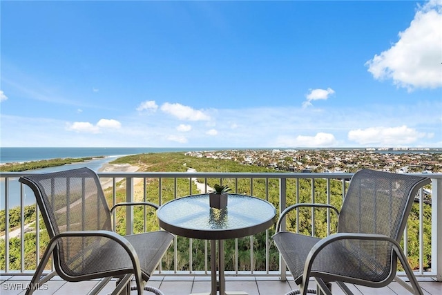 balcony featuring a water view and a beach view