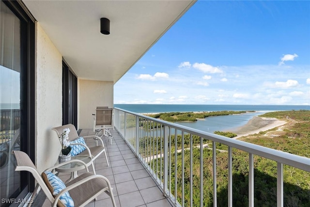 balcony with a view of the beach and a water view