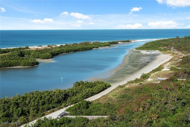 birds eye view of property with a water view and a beach view