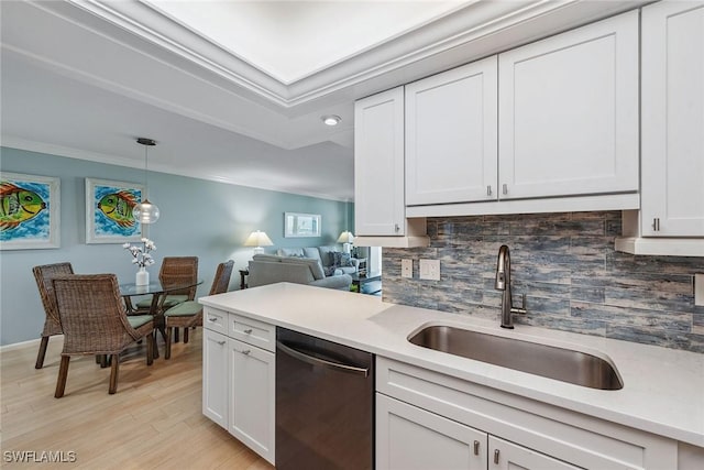 kitchen with crown molding, dishwasher, light wood-type flooring, and sink