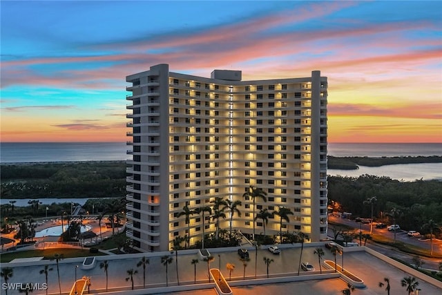 outdoor building at dusk featuring a water view