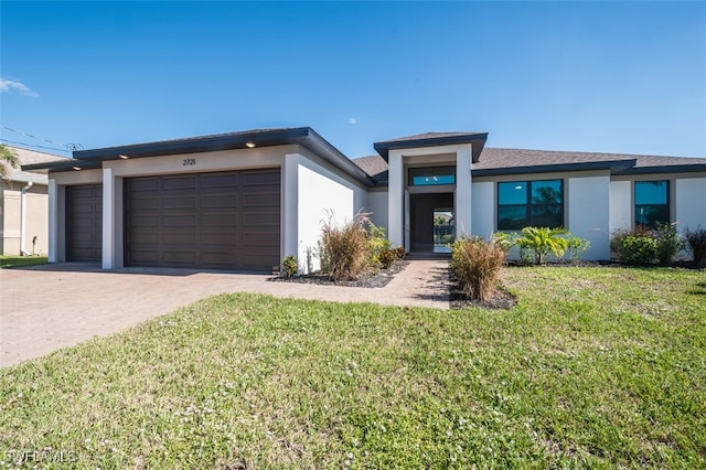 view of front of property featuring a front lawn and a garage