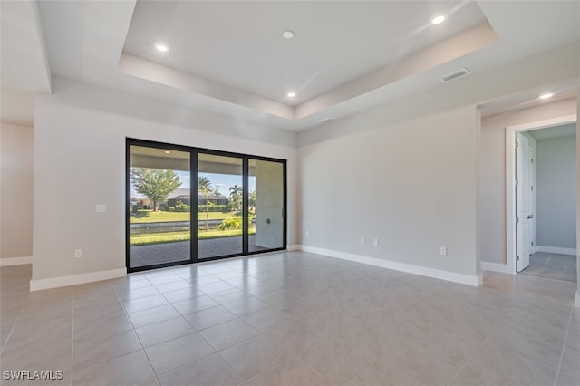 empty room with a raised ceiling