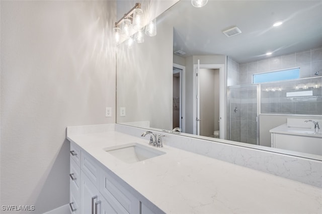 bathroom featuring vanity, an enclosed shower, and toilet