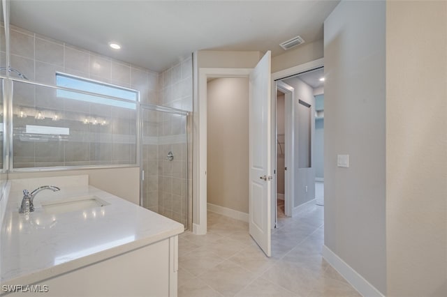 bathroom with tile patterned flooring, vanity, and an enclosed shower