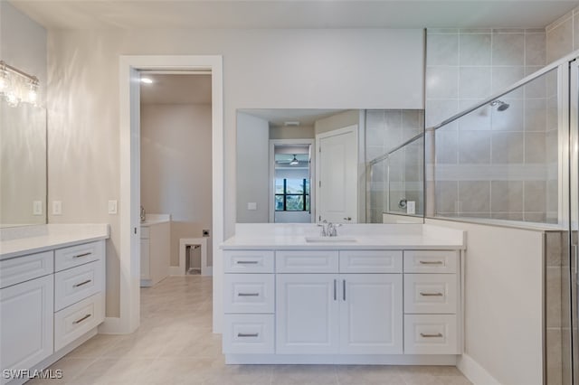 bathroom with tile patterned floors, vanity, and walk in shower