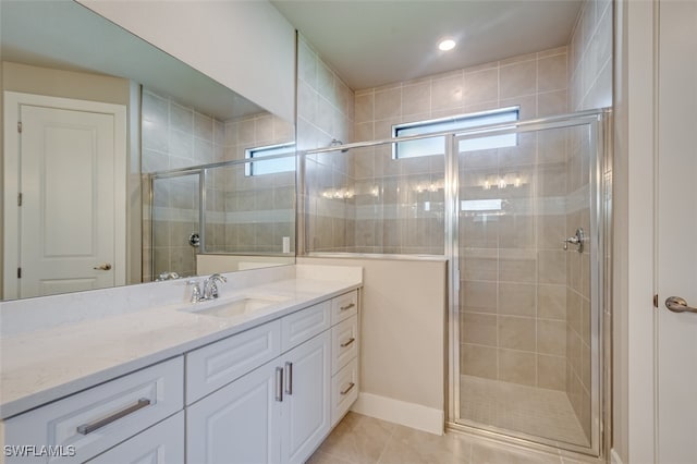 bathroom with tile patterned flooring, vanity, and a shower with shower door