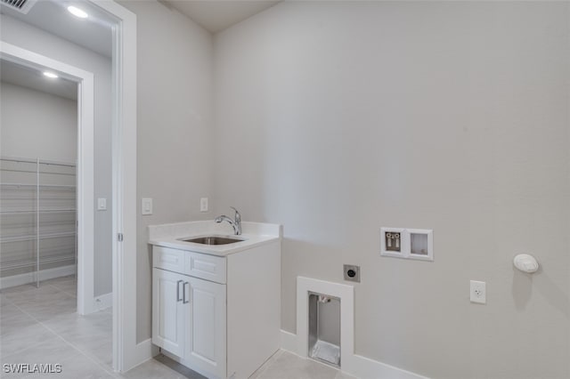 laundry room with hookup for an electric dryer, light tile patterned floors, sink, and hookup for a washing machine