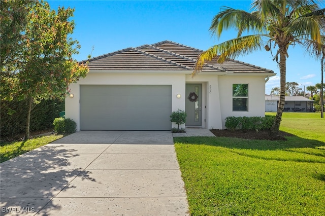 view of front of home with a front yard and a garage