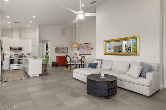 living room with ceiling fan and high vaulted ceiling