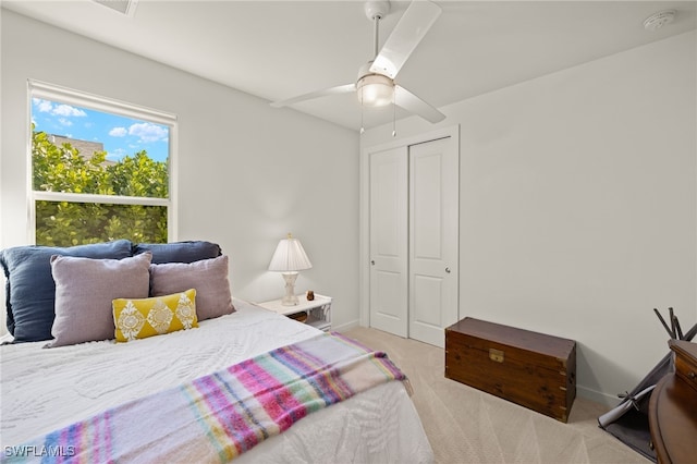 carpeted bedroom with a closet and ceiling fan