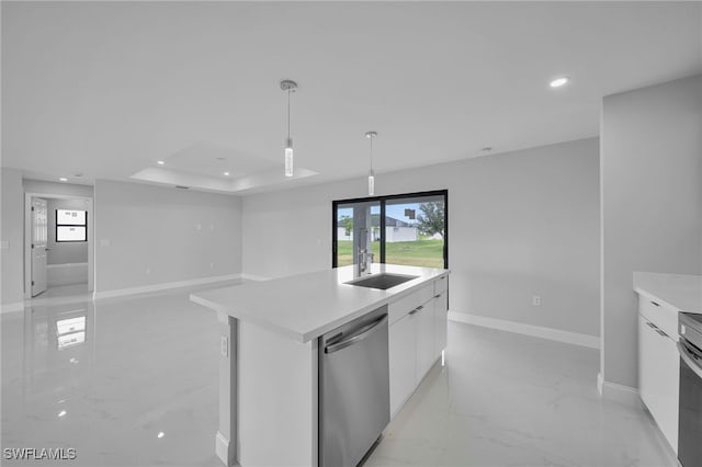 kitchen featuring appliances with stainless steel finishes, pendant lighting, sink, white cabinets, and a kitchen island with sink