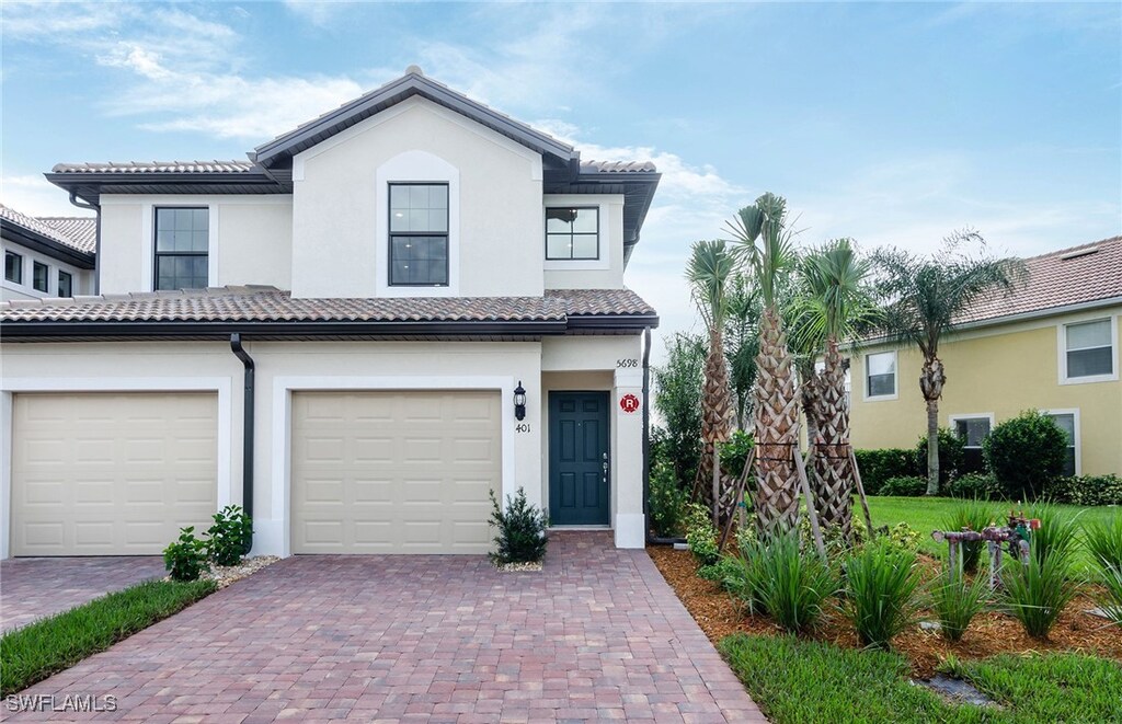 mediterranean / spanish house featuring a garage