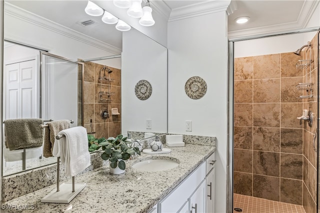 bathroom with vanity, an enclosed shower, and ornamental molding