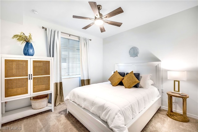 bedroom featuring ceiling fan and carpet