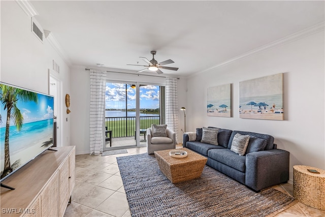 tiled living room with ceiling fan, a water view, and ornamental molding