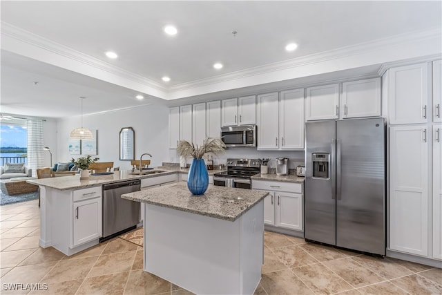 kitchen featuring pendant lighting, a center island, white cabinetry, and appliances with stainless steel finishes