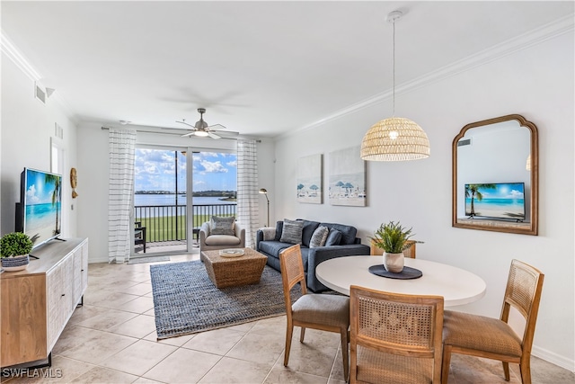 tiled dining room with ceiling fan and ornamental molding