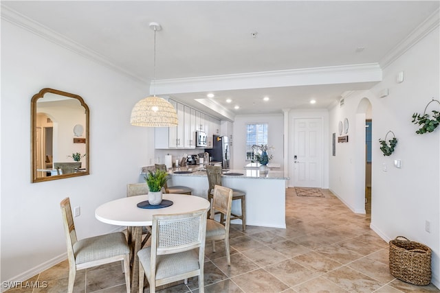 dining space with ornamental molding