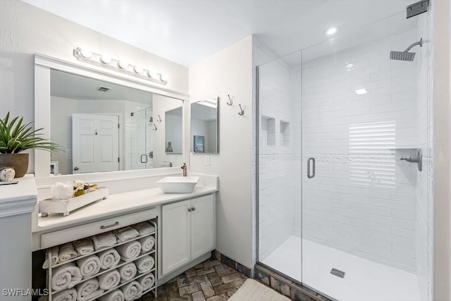 bathroom featuring vanity and a shower with shower door