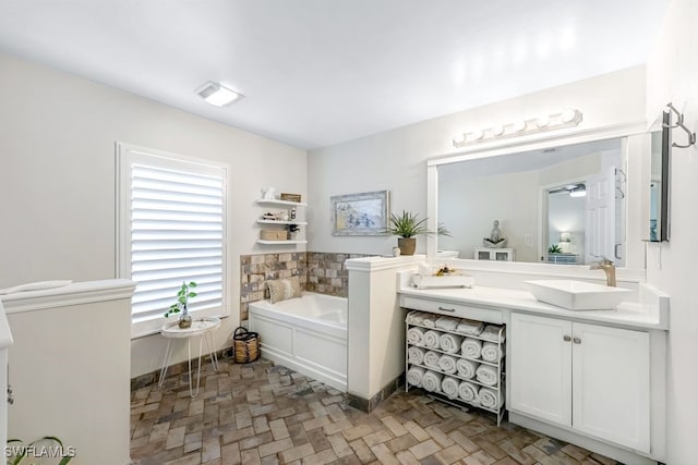 bathroom with a washtub and vanity