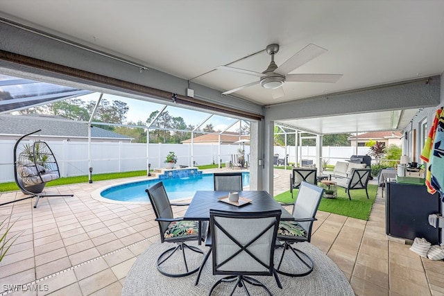 view of patio with pool water feature, a fenced in pool, glass enclosure, and ceiling fan