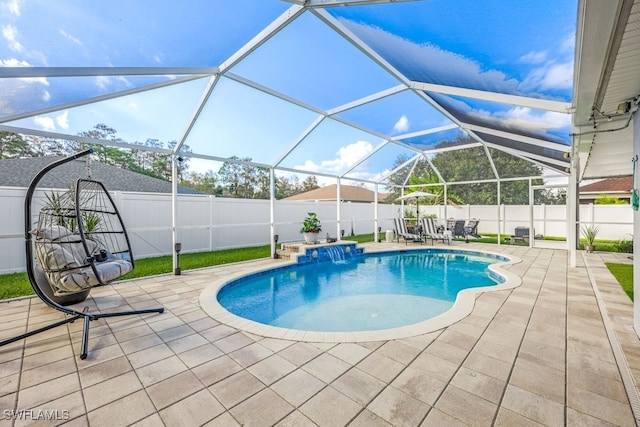 view of pool with pool water feature, a lanai, and a patio area