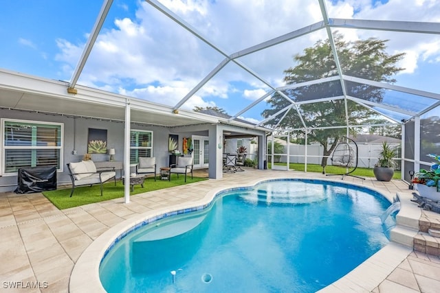 view of swimming pool with glass enclosure, french doors, pool water feature, a storage unit, and a patio area