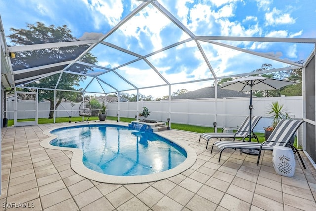 view of swimming pool featuring pool water feature, a patio, and a lanai