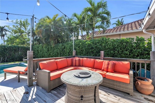 deck featuring an outdoor hangout area and a fenced in pool