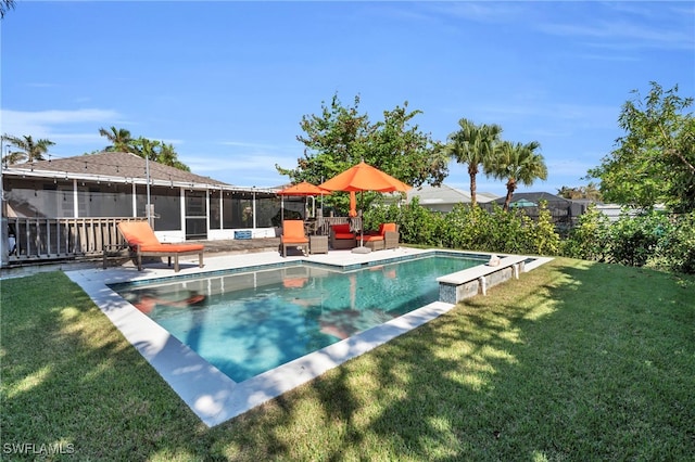 view of swimming pool with a sunroom, a patio area, and a lawn