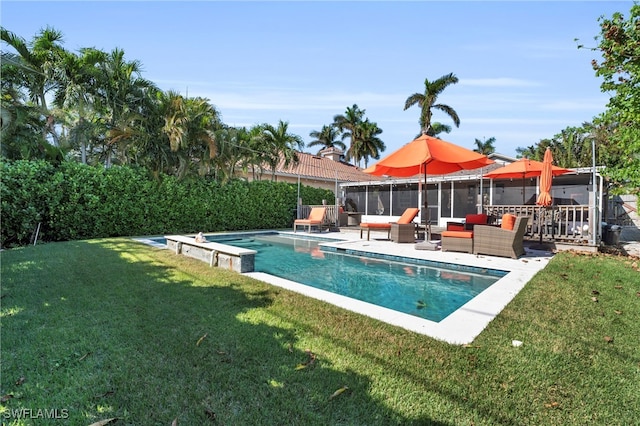 view of pool with outdoor lounge area, a yard, and a patio