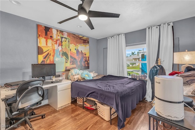 bedroom with hardwood / wood-style floors and ceiling fan