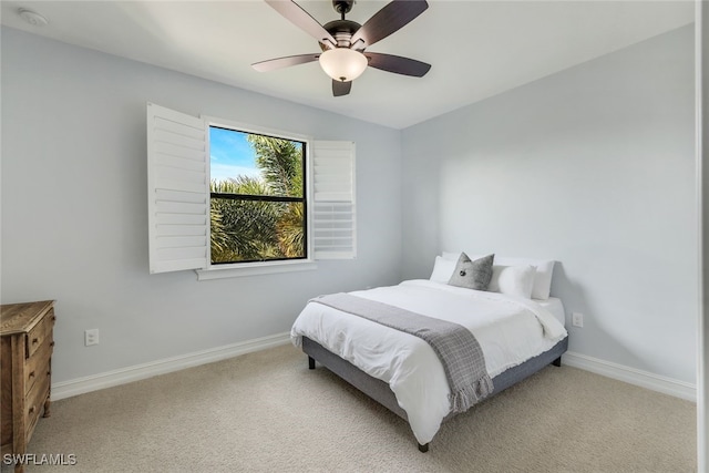 bedroom with ceiling fan, light carpet, and vaulted ceiling