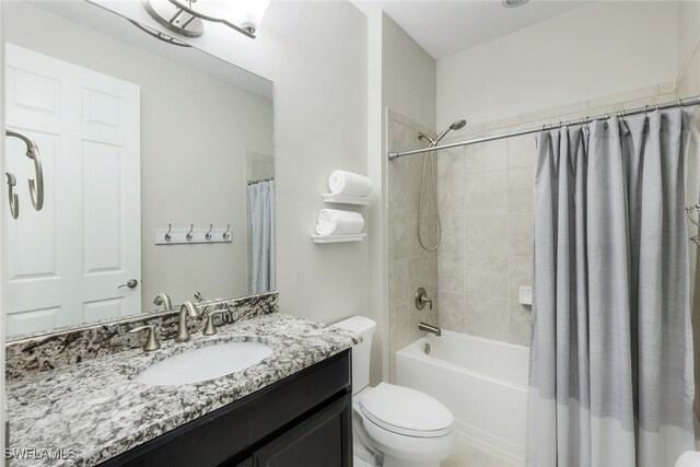 bathroom featuring vanity, toilet, and shower / bath combo with shower curtain