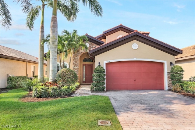 mediterranean / spanish home featuring a front lawn and a garage