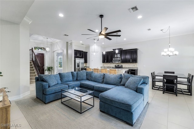 tiled living room featuring ornamental molding and ceiling fan with notable chandelier