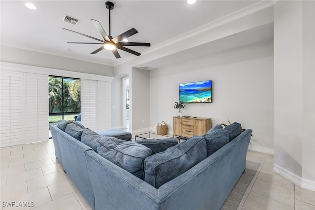 living room featuring ceiling fan, light tile patterned flooring, visible vents, baseboards, and crown molding