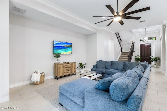 tiled living room featuring ceiling fan and crown molding